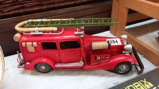 A large pressed steel and fibre glass model of a vintage American fire engine length 36cm