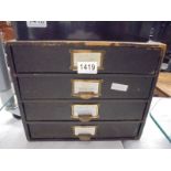 A vintage four drawer filing box.