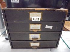 A vintage four drawer filing box.