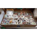 A box of cigarette and collectors cards including Topps chewing gum, football cards