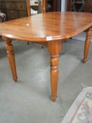 A pine extending dining table with one leaf, COLLECT ONLY.