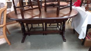 A dark oak oval dining table COLLECT ONLY
