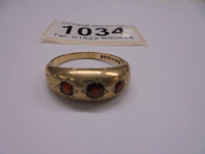 A 9ct gold three stone garnet ring, size P, 3.15 grams. - Image 2 of 2