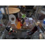 A glass duck and shoe with alcohol contents and three other glass items.
