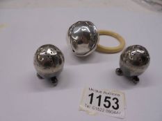 A child's silver rattle dated Birmingham 1918 together with a pair of silver salts, Sheffield 1884.