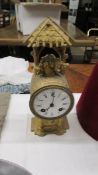A 19th century gilt clock in working order but missing glass.