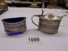 A silver salt and mustard pot with blue glass liners (mustard liner chipped).