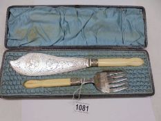 A cased pair of ornate silver plate fish servers.