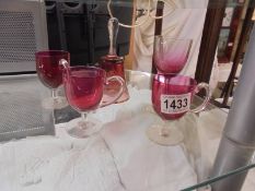 Five pieces of cranberry glass.