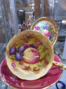 An Aynsley hand painted tea cup and saucer signed D Jones and a Paragon hand painted oval plaque.