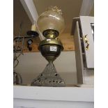 An old oil lamp on cast base with brass font. COLLECT ONLY.