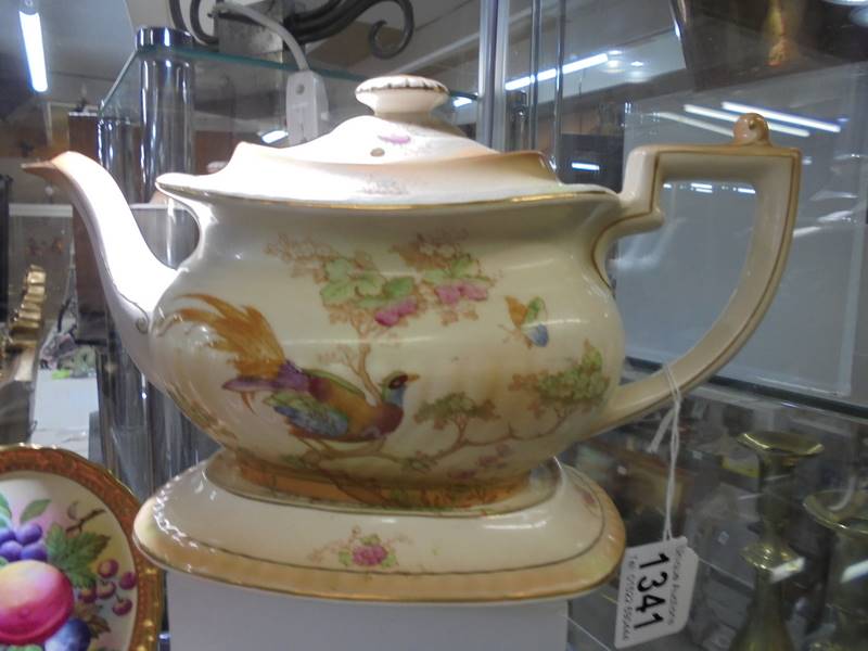 A Crown Ducal teapot on stand.
