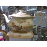 A Crown Ducal teapot on stand.