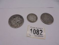 An 1801 George IIII silver coin, an 1821 George IIII silver coin and a Victoria silver florin.