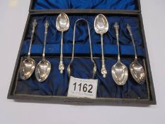 A cased set of six silver apostle spoons with sugar nips.