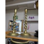 A pair of brass barley twist candlesticks.