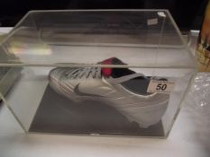 A cased signed Eric Cantona football boot with certificate
