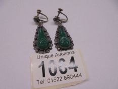 A pair of silver and jade pendant earrings.