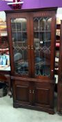 A dark oak corner cupboard with leaded glass doors COLLECT ONLY