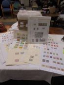 A box containing a large quantity of mini collections of stamps from many countries of the world,