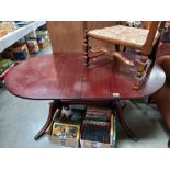 A dark wood stained oval extending dining table COLLECT ONLY