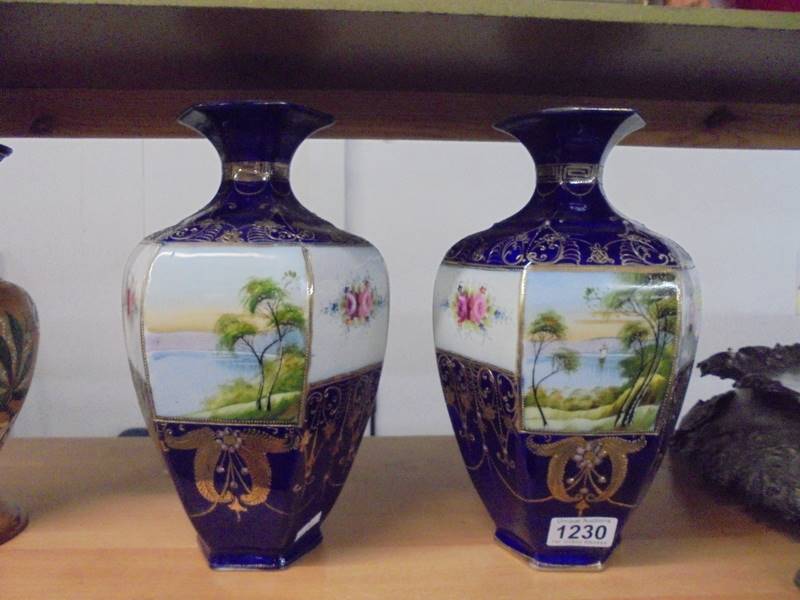 A pair of hand decorated oriental vases marked Kinso-Nippon