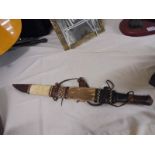 A tribal hunting knife in sheath,