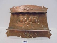 An Arts & Crafts/Art Nouveau copper pipe rack, 34 x 24 cm.