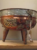 An Indian copper cauldron on 3 legs overlaid with silver plated decoration, diameter 25cm, height