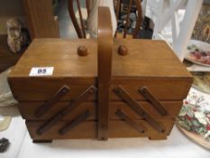 A vintage concertina sewing box + content, including cotton reels, buttons etc