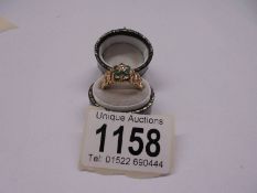 An emerald/diamond ring in textured 9ct gold mount, hallmarked London 1971, size N half, 3.6 grams.