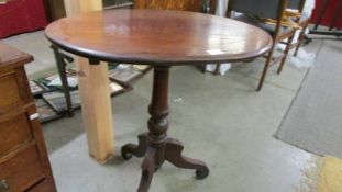 An oval mahogany occasional table on tripod legs, COLLECT ONLY.