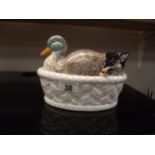 A duck lidded serving dish with matching spoon