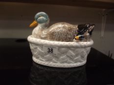 A duck lidded serving dish with matching spoon