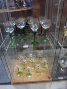 Eighteen green stemmed wine goblets, (two shelves) COLLECT ONLY.