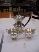 A silver coffee pot, sugar bowl and milk jug,