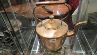 A large old copper kettle.