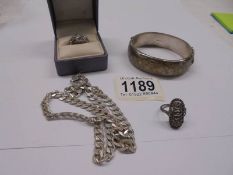 A silver bangle, silver chain and two silver rings, 47 grams.