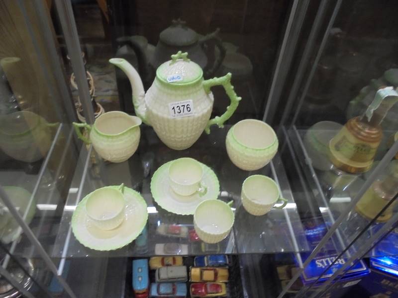 A Belleek teapot, sugar bowl, milk jug, four tea cups and three saucers.