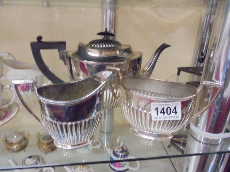 A three piece silver plate tea set.