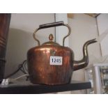 A Victorian copper kettle.