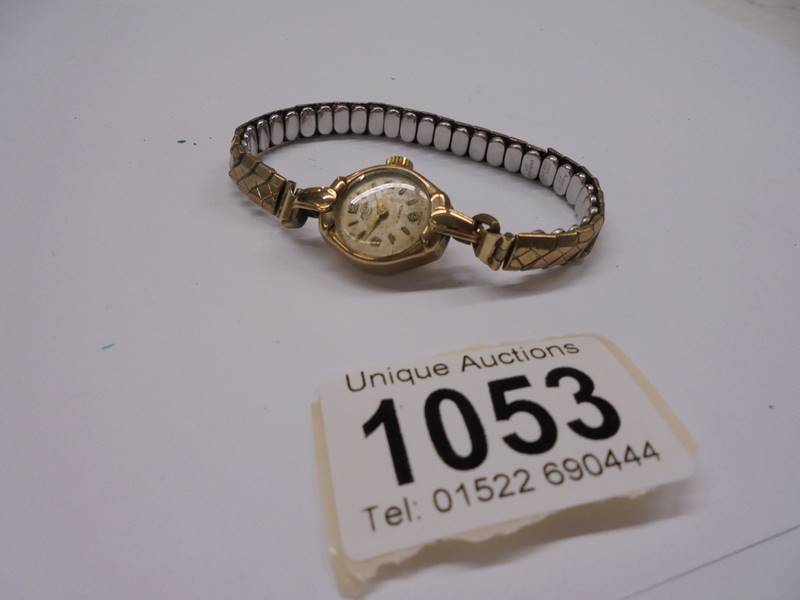 A 9ct gold Enidor Swiss 17 jewel ladies wrist watch on metal bracelet.