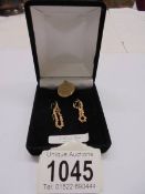 A pair of 9ct gold earrings and a 9ct gold 'Libra' pendant, 2.7 grams.