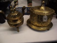 A Chinese brass insence burner and a hammered brass tobacco tin