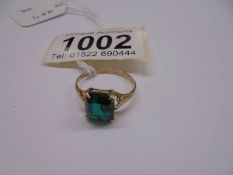 A yellow gold ring set green coloured stone, size M half, 1.8 grams.