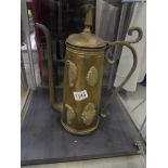 A large copper pot with brass embellishments.