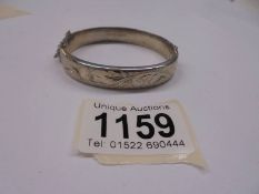 A vintage style silver engraved bangle, hall marked Birmingham 1979.