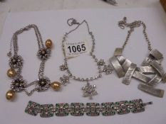 Three vintage necklaces and a bracelet.