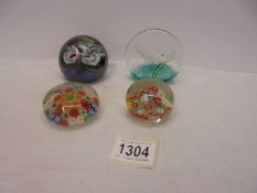 A Caithness limited edition 93/500 Salmon paperweight, two millifiori paperweights and one other.