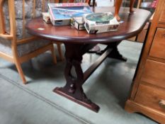 A dark oak oval dining table COLLECT ONLY